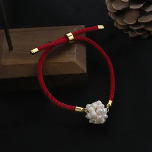 Handmade red string bracelet featuring a white freshwater pearl flower ball charm