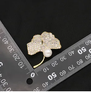 Detailed view of luxury ginkgo leaf brooch featuring freshwater pearl and micro-crystals
