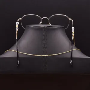 Minimalist gold eyeglasses chain shown from back view on a black display neck