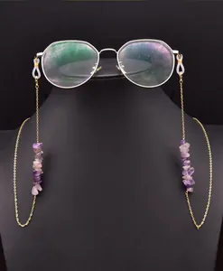 Detail view of a gold-toned eyeglass chain featuring natural purple amethyst stones