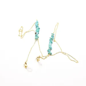 Detailed view of bohemian turquoise crushed stone eyeglass chain with gold metal finish