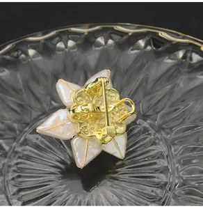 Back view detail of handmade Baroque pearl sunflower brooch with gold-plated pin clasp