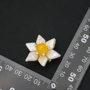 Exquisite vintage baroque pearl sunflower brooch featuring a yellow gemstone and scale reference