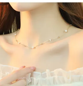 Elegant freshwater pearl and gold bead necklace on a female model's collarbone.