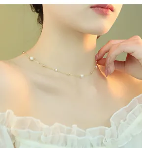 Close-up of delicate gold starlight necklace with natural freshwater pearls and beads