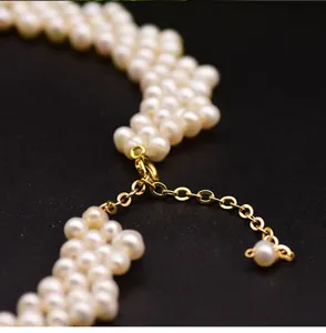 Close-up of handcrafted woven freshwater pearl necklace with gold-plated clasp