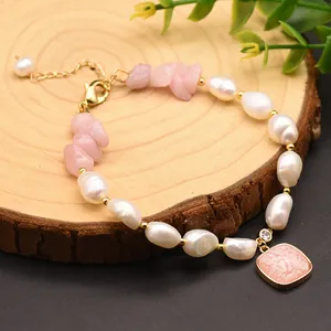 Close-up showing the natural texture of baroque pearls and pink crystals on a wooden stand