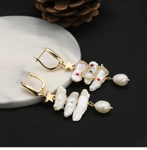 Detailed view of vintage Baroque pearl drop earrings with gold star accents and S925 hooks