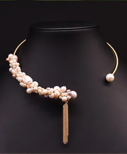 Detailopname van elegante zoetwaterparel choker ketting met gouden kwastje detail