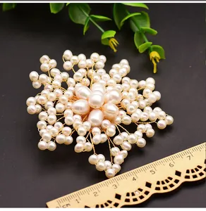 Macro detail of natural freshwater pearl flower brooch featuring a ruler to show product scale
