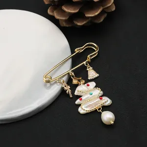 Elegant freshwater pearl Christmas tree brooch pin with gold finish and festive charms.