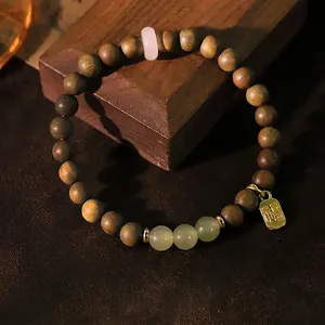 Handcrafted green sandalwood and Hetian jade bracelet with golden blessing charm