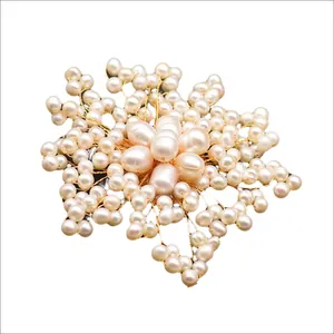 Elegant handmade flower brooch crafted with natural freshwater pearls and gold wire accents