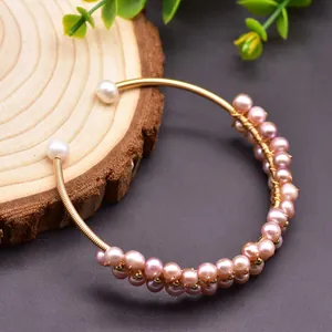 Detailed macro view of handmade wire-wrapped natural freshwater pearl elastic bangle