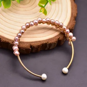 Close-up of handmade wire-wrapped natural pearl bracelet with pink and white pearls