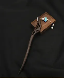 Detailed view of handmade wooden antique hairpin with pearl tassels and blue floral cloisonné.