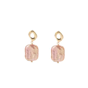 Natural baroque pearl drop earrings with hollow rhombus gold-tone studs and pink luster.