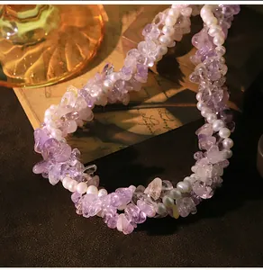Close-up of triple-strand amethyst and natural pearl necklace with vintage background