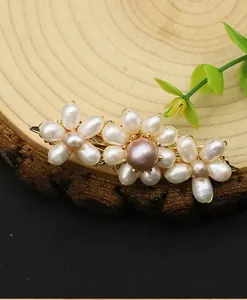 Close-up detail of a handmade natural pearl flower hair clip with elegant golden finish