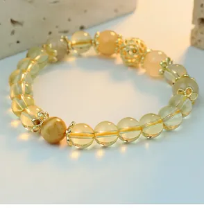 Close-up of a yellow crystal beaded bracelet with intricate golden filigree accents
