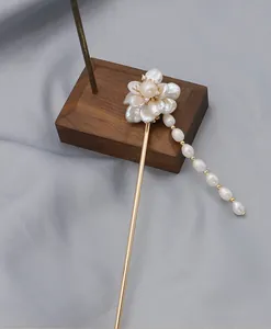 Detailed view of handmade baroque pearl flower hairpin with elegant dangling tassels