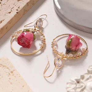 Elegant natural pearl earrings with pink dried rose buds and crystal accents