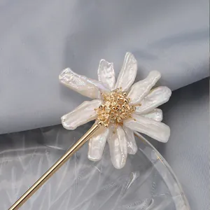 Close-up of Baroque pearl sunflower hair stick with 18K gold-plated floral detail