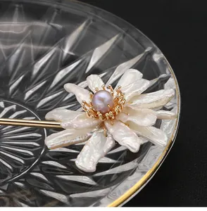 Close-up macro detail of a handcrafted natural baroque pearl sunflower hairpin in gold