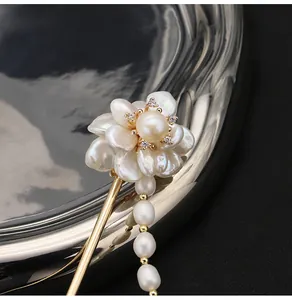Detailed close-up showing texture of baroque pearl flower hairpin with gold-plated tassel