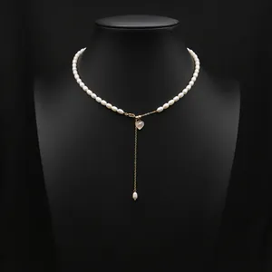 Elegant natural freshwater pearl necklace with gold chain and pink heart pendant on bust.