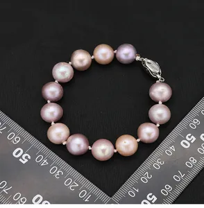 Detailed view of a multi-color natural Edison pearl bracelet next to a scale ruler