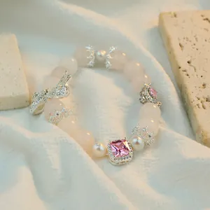 Luxurious pink crystal beaded bracelet featuring a silver bow and square pink gemstone