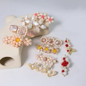 Elegant handmade natural pearl hair clips with vintage floral designs on display