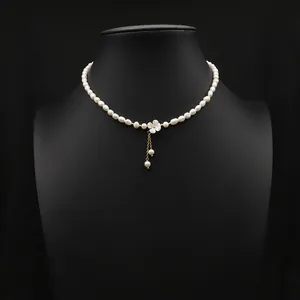 Elegant natural pearl choker necklace featuring a delicate white shell flower pendant