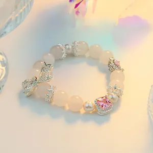 Elegant pink crystal beaded bracelet with silver bow and crown charms for women