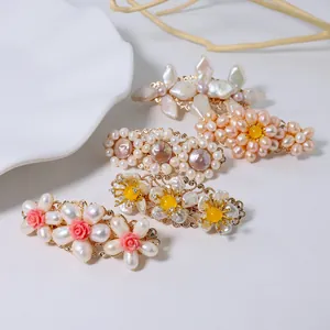 Elegant handmade vintage floral hair clips featuring natural pearls on a white background.