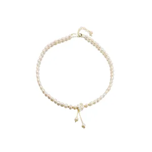 Elegant natural pearl necklace featuring a delicate white flower pendant and gold clasp