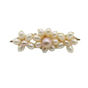 Elegant handmade hair clip with natural pink and white pearls in a floral design