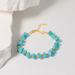 Detail view of handmade turquoise wire-wrapped bracelet with irregular natural stones