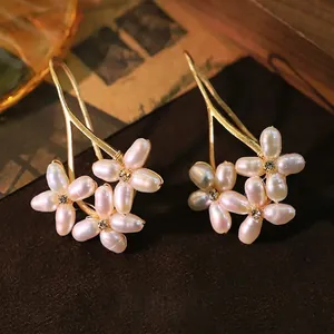 Elegant natural freshwater pearl flower earrings in a refined vintage gold finish style.