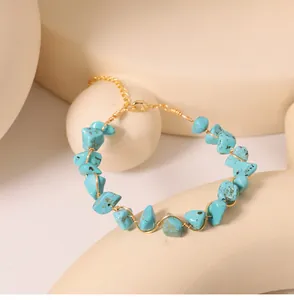 Detailed view of turquoise stone chips and gold-colored wire-wrapped bracelet design