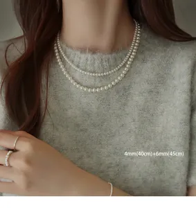 Detail view of double layered pearl necklace set with 4mm and 6mm pearls on model