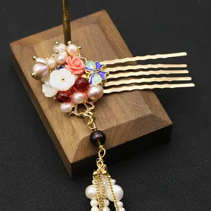 Close-up of Chinese style hair comb with natural pearls and cloisonné butterfly