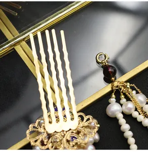 Close-up of traditional Cloisonné hair comb with natural pearls and golden tassels