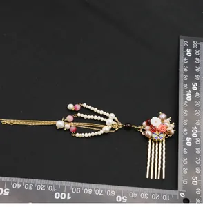 Macro detail of a traditional Chinese hair comb with natural pearls and butterfly.