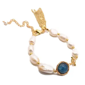 Handmade bohemian baroque pearl bracelet with blue gemstone and gold-toned chain.