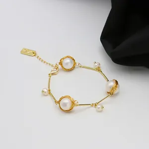 Close-up of handmade 18k gold wire-wrapped natural freshwater pearl bracelet with vintage style