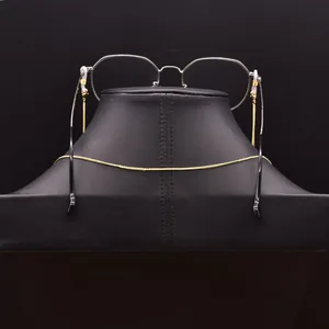 Elegant gold glasses chain with anti-slip rubber loops shown on a professional display bust