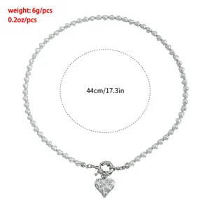 Detailed view of a heart beaded necklace with 44cm length and a rhinestone pendant