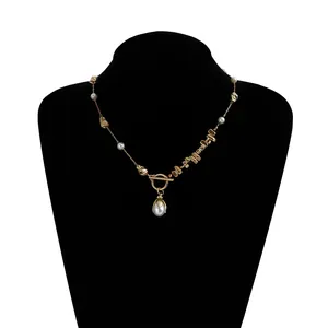 Detail view of an irregular metal and pearl necklace on a black jewelry bust.